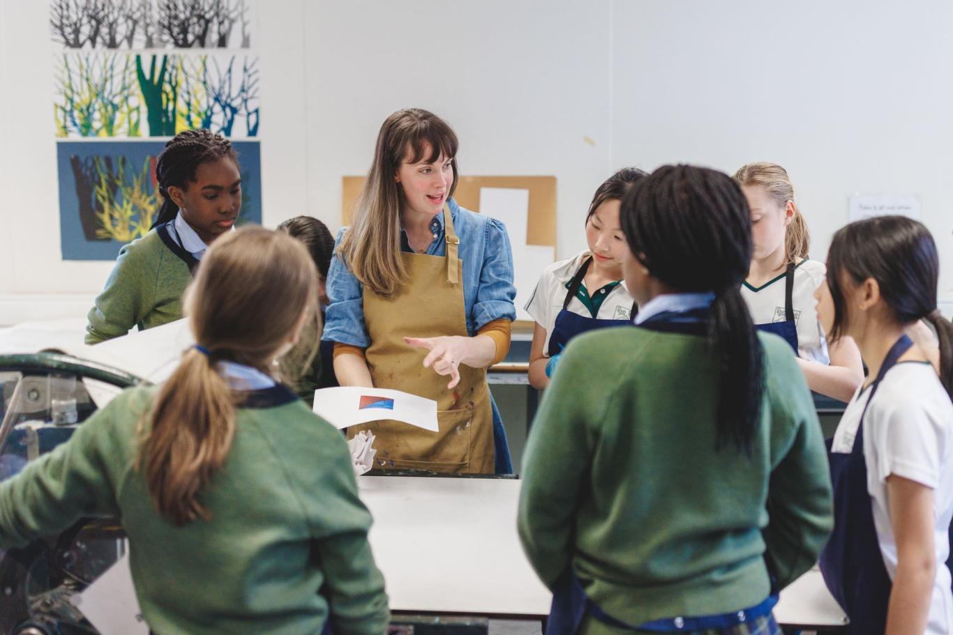 A teacher works with a group of LC1 (year 7) students during Art printmaking lesson at CLC