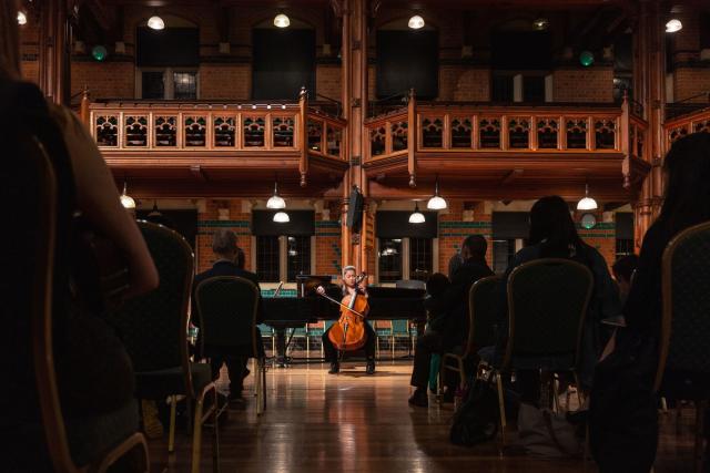 A CLC music scholar plays the Cello in a concert hosted in the Princess Hall