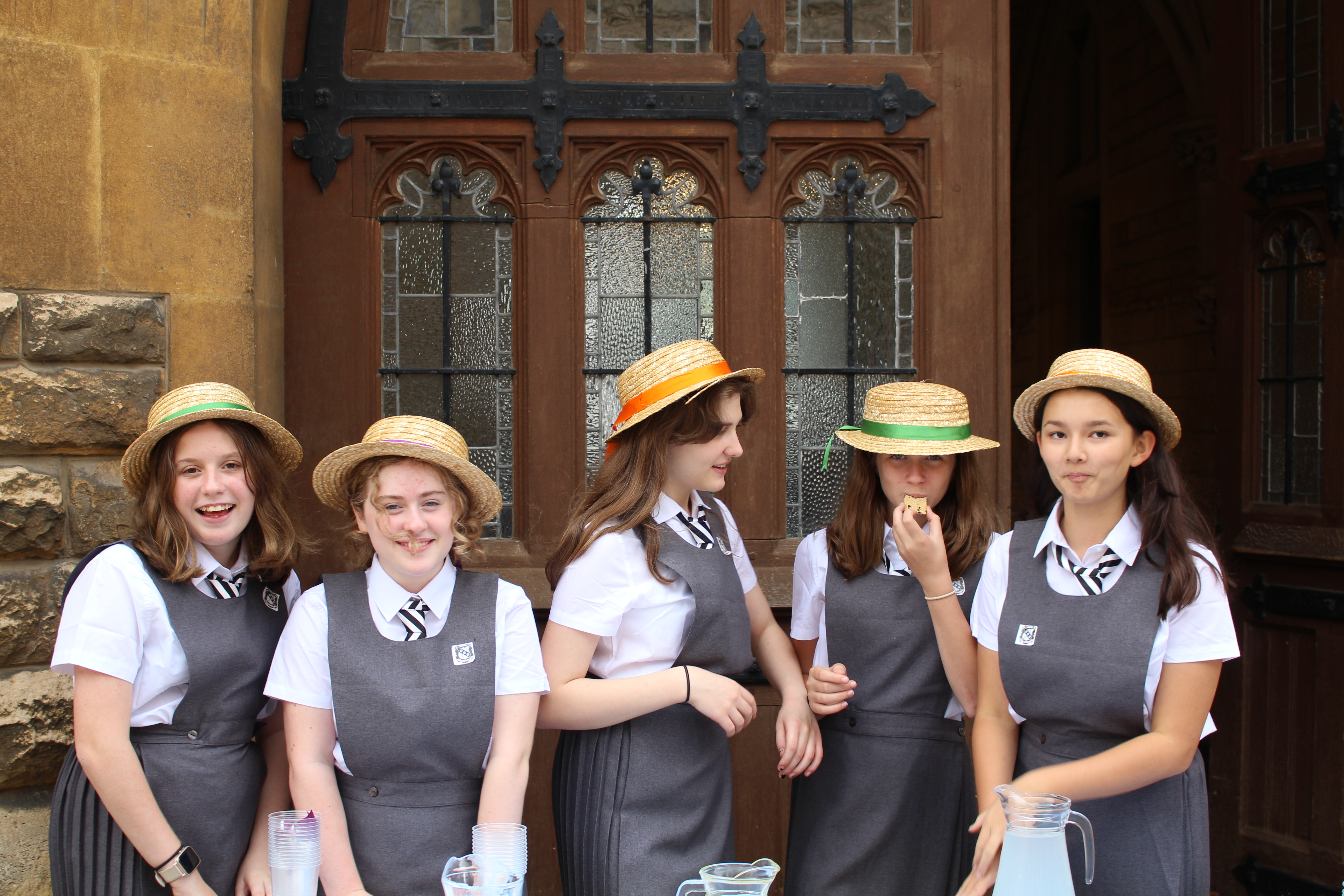 Five pupils dressed as schoolgirls from the book, Murder Most Unladylike